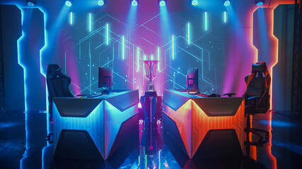 Two Person Empty Computer Gaming eSports Championship Arena with Winner Trophy Standing on a Stage. Stylish Online Live Streaming Tournament with Big Screens Showing Graphics and Neon Stage © Gorodenkoff