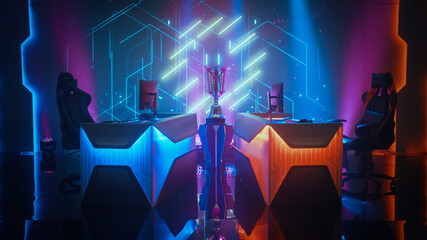 Two Person Empty Computer Gaming eSports Championship Arena with Winner Trophy Standing on a Stage. Stylish Online Live Streaming Tournament with Big Screens Showing Graphics and Neon Stage © Gorodenkoff
