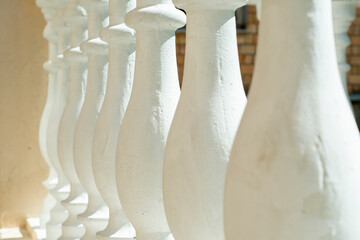 A row of white columns in a classic style on the balustrade