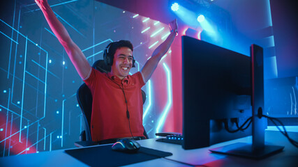 Professional eSports Gamer Playing in Computer Video Games, Happily and Cheerfully Celebrates Victory and Success. Online Cyber Championship / Tournament. Portrait Shot © Gorodenkoff
