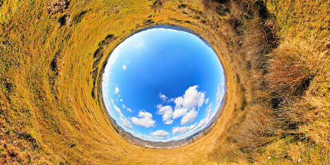 Panorama of a late winter field in full sun with very blue sky and white clouds. Stereographic panoramic projection - 435851006
