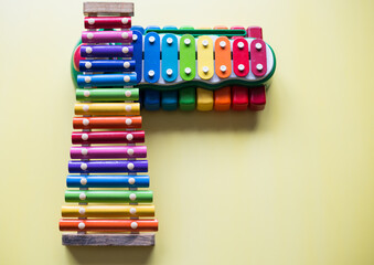 Overhead shot of toy xylophones music equipment on a yellow surface