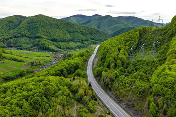 Long Curvy Forest Road In Mountains aerial view