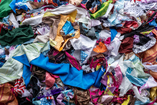 The background of the rag pieces of various colors are stacked together in a scattered mess.