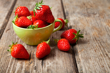 Ripe strawberries in a green cup