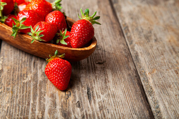 Ripe strawberries in a wooden plate