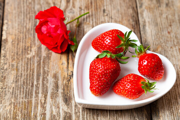 Ripe strawberries in a heart shaped plate