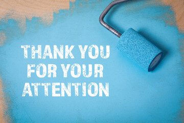 THANK YOU FOR YOUR ATTENTION. Paint roller with blue paint on a wooden surface