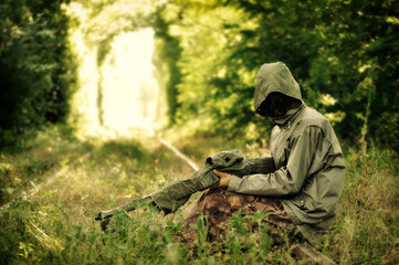 Naklejka premium Camouflage hunter aiming with his rifle