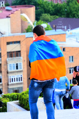Yerevan Armenia - 05192018: a young man wearing an Armenian National Flag during 2018 Peaceful Protest