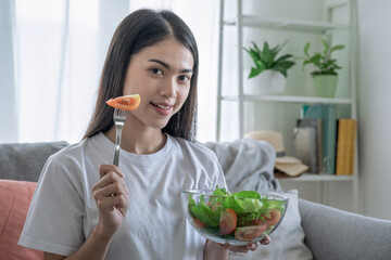 Asian young woman eating vegetable salad, Eating good food for good health, Organic Salad.