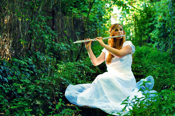 Girl playing on a flute © Mihai