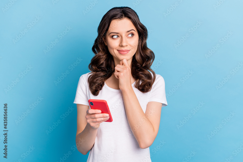 Sticker photo of cute sweet young woman wear white t-shirt holding modern device smiling isolated blue color