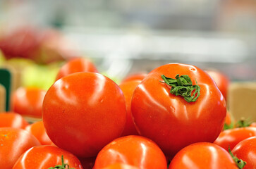 Fresh tomatoes in a market stall.