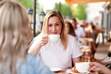 Young woman drinking a coffee in a cafe terrace