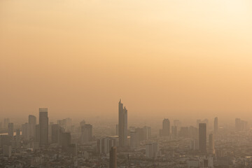 Fototapeta na wymiar Bangkok city skyline at melacholic lonely misty sunset view from Baiyok ii Tower