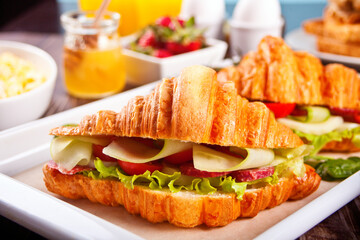 Croissant sandwiches with ham and cheese Breakfast concept.
