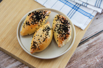 traditional baked Turkish pies with black cumin sprinkles