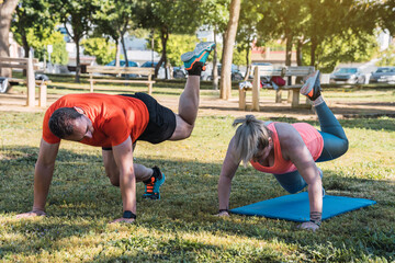 Woman doing exercises with a personal trainer outdoors