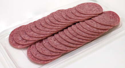 Sliced cervelat sausage in fast food retail plastic container from market