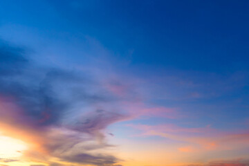 Twilight blue bright and orange yellow dramatic sunset sky in countryside or beach colorful cloudscape texture with white clouds air background.