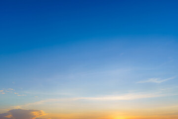 Twilight blue bright and orange yellow dramatic sunset sky in countryside or beach colorful cloudscape texture with white clouds air background.