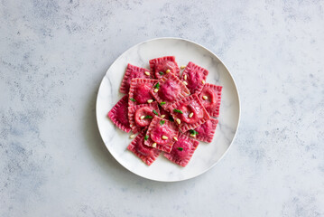 Beet ravioli with ricotta cheese, spinach and nuts. Healthy eating. Vegetarian food. Italian cuisine.