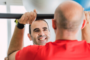 Personal trainer smiling in front of a client