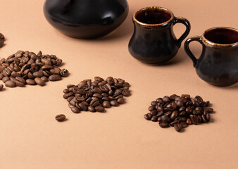 Different roasted coffee beans.Three varieties of coffee beans on the background of cups. 