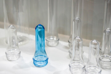 The sample parts injection preform shape of PET bottle products. The plastic bottle manufacturing process concept.