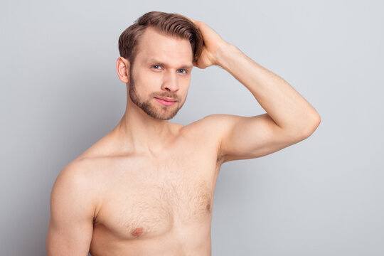 Photo of serious blond hairdo guy touch hair without clothes isolated on grey color background