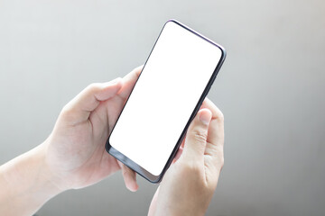 Hand holding and using smartphone with white blank on screen.