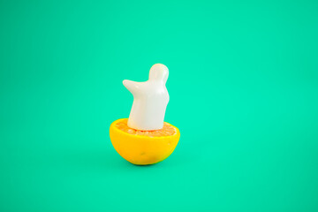The white figure of a man on an orange shows his hand and a blue-green background. Pastel colors and space for text. Summer parties are coming.