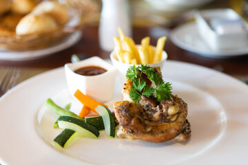 A fried chicken dish with boiled vegetables and french fried