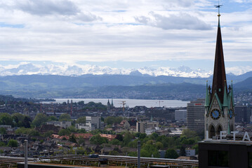 Fototapeta premium Zurich skyline at springtime with Lake Zurich and Swiss alps in the background. Photo taken May 26th, 2021, Zurich, Switzerland.