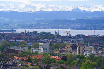 Zurich skyline at springtime with Lake Zurich and Swiss alps in the background. Photo taken May 26th, 2021, Zurich, Switzerland.