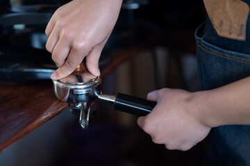 Close up of barista hands grinding coffee