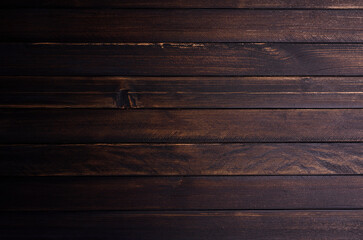 Old wooden table in kitchen or interior, vintage atmosphere on a dark background. Or black on a...