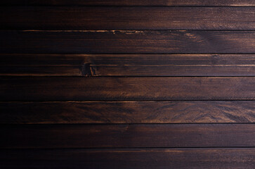 Old wooden table in kitchen or interior, vintage atmosphere on a dark background. Or black on a brown board Suitable for use as a backdrop or display.