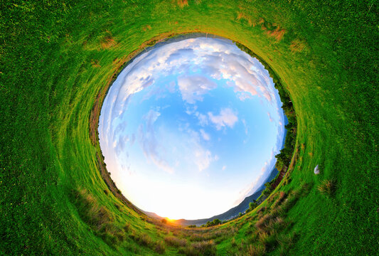 Stereographic panoramic projection of a green field in the summer. 360 degree panorama.