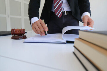 Justice and law concept. Gavel on sounding block in hand's Male judge at a courtroom, working with...
