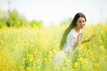 Young woman in the rapeseed field