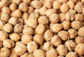 Many dry chickpeas texture. High protein superfood ingredient. Legume used as  flour or in hummus, veggie burgers and falafel. Known as garbanzo bean, bengal gram or Cicer arietinum. Selective focus.