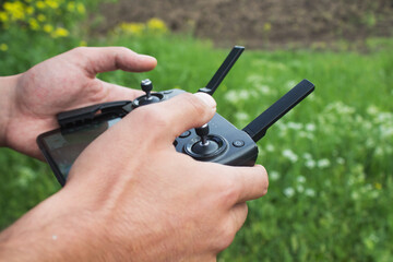 a man controls the drone's remote control