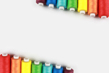Creative background-layout of colored rainbow threads for sewing with a needle. Handmade concept,...