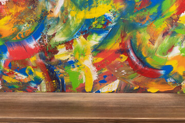 Fototapeta premium Colorful painted background texture at wooden table. Abstract oil painting