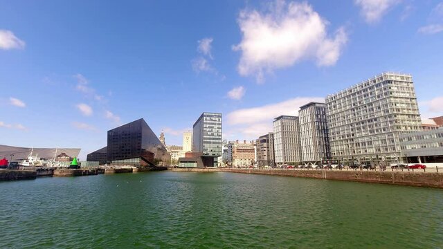 Time lapse clouds passing over contemporary modern urban city business waterfront buildings skyline