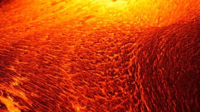 A river of incandescent lava pours out. Tons of hot magma spills