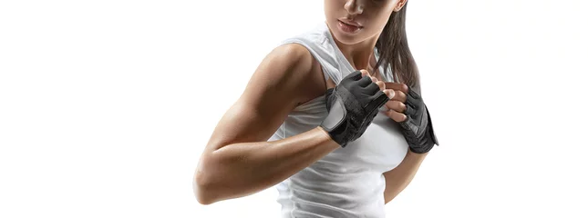 Wall murals Fitness Croped shot of fitness confident female bodybuilder with power hands in gloves isolated on white. Copy space.