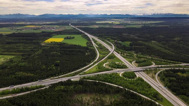 Drone Aerial view of a german Autobahn motorway leading to the alps and mountains in , traffic 4K